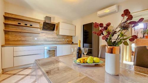 a kitchen with a table with a vase of flowers at Stefi 1 in Crveni Vrh