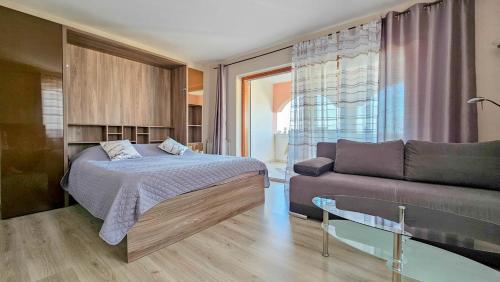 a bedroom with a bed and a couch at Stefi 1 in Crveni Vrh