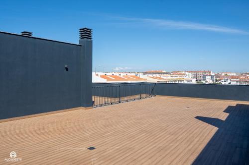 a large balcony with a view of a city at Varanda do Guincho - Classy Apt in Santa Cruz in Silveira