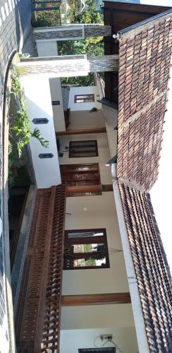 an aerial view of a house with a building at Beegees Homestay in Pīrmed