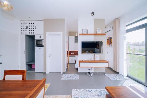 a kitchen with white walls and a large window at 1 BDR Garden Apartment at The Soul, Paje in Paje