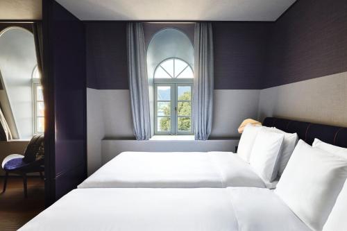 a bedroom with two beds and a window at Hotel Indigo Nagasaki Glover Street by IHG in Nagasaki