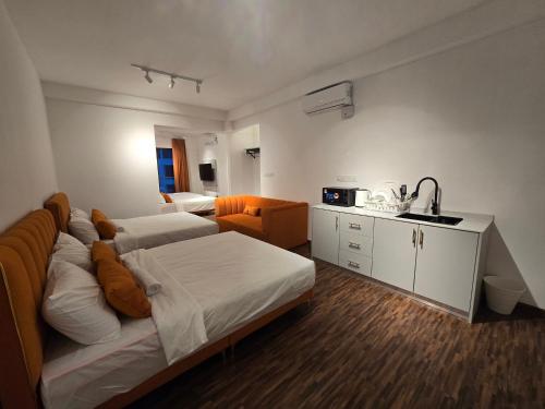 a bedroom with a bed and a sink in it at K Avenue Kota Kinabalu by Merveille - Sabah in Donggongon
