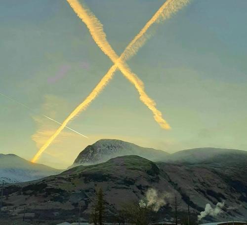an x pattern in the sky over a mountain at Nevis Rooms - Self check in with free onsite Parking in Inverlochy