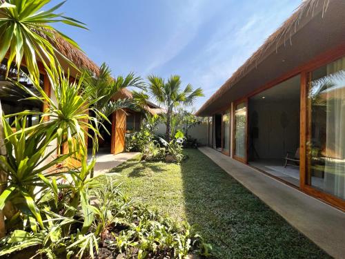 an empty courtyard of a house with palm trees at Wild Cottages Elephant Sanctuary Resort in Amphoe Koh Samui