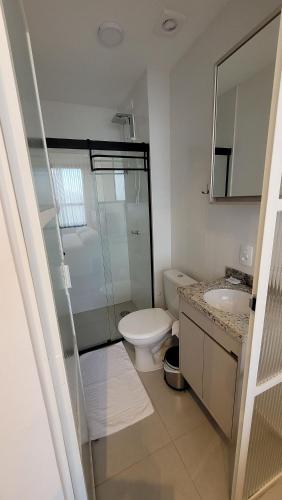a white bathroom with a toilet and a sink at Blend Coliving One - 1 in Ribeirão Preto