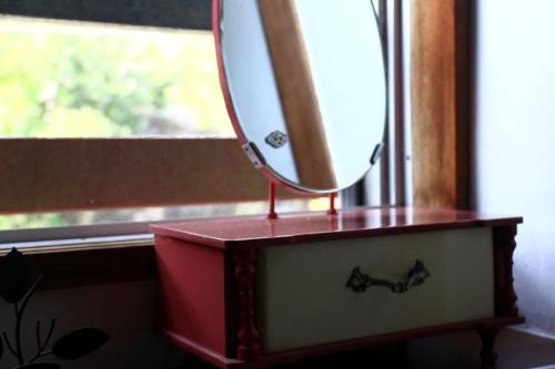 a mirror sitting on top of a dresser at ホテル宿かいふ in Kaiyo