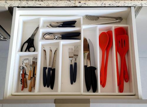 a drawer full of utensils in a white box at Blend Coliving One - 1 in Ribeirão Preto