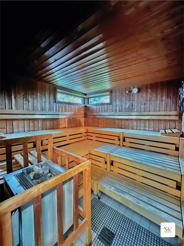 a large room with wooden benches in a sauna at WAGNERS Hotel Schönblick, C&C Hotels und Vertrieb GmbH in Fichtelberg