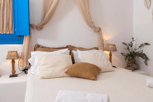 a bedroom with a bed with white pillows at Blue Meadow in Livadi Astypalaias