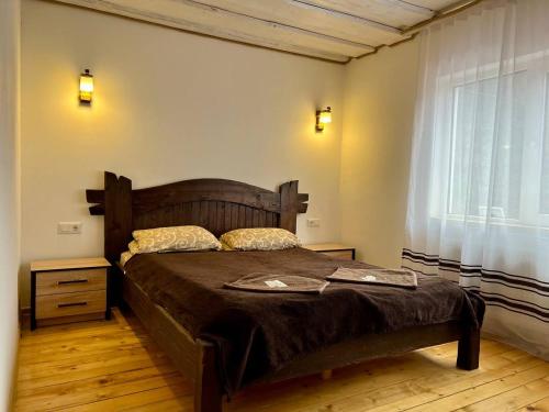 a bedroom with a large bed and a window at Готель-кафе Чатина in Soymy