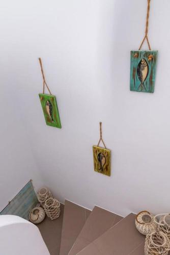 a room with a table with pictures on the wall at Blue Meadow in Livadi Astypalaias