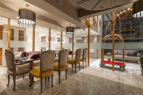 a dining room with a table and chairs at Mastiff Select Mandavya Dharamkot, McLeodganj in Dharamshala