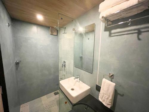 a bathroom with a sink and a mirror at Bandra Stays in Mumbai