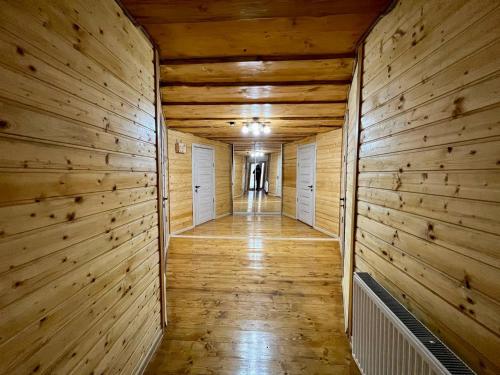 an empty hallway with wooden walls and wooden flooring at Готель-кафе Чатина in Soymy