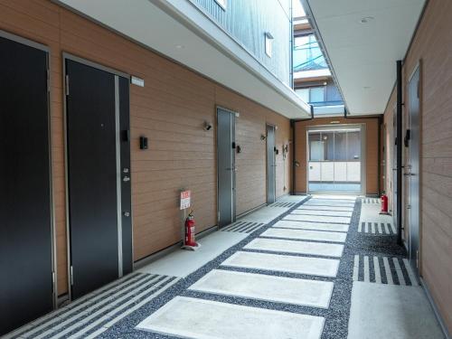 a hallway of a building with doors and a fire hydrant at OUCHI HOTEL Onaganishi in Hiroshima