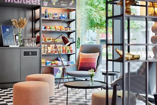 a store with two chairs and a table andools at LÉGÈRE EXPRESS Tuttlingen in Tuttlingen