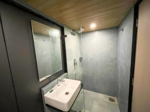 a bathroom with a sink and a mirror and a shower at Bandra Stays in Mumbai