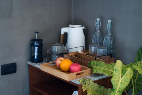 a wooden tray with fruits and vegetables on a counter at Inigtan Lio Villas in El Nido