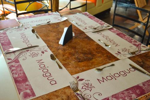 a table with three napkins on top of it at Bon Jesus Hotel in Costa Esmeralda