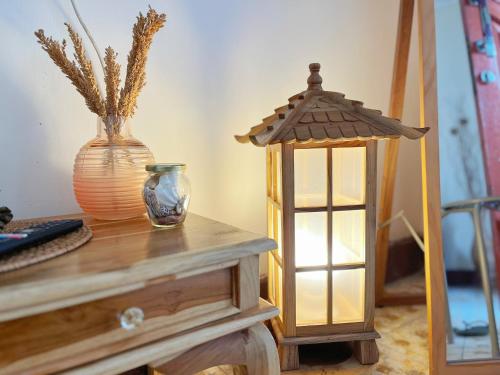 a table with a lantern and a vase on it at Bohaus in Alastuwo