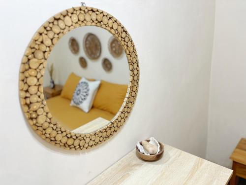 a mirror on a wall with a couch in a room at Bohaus in Alastuwo