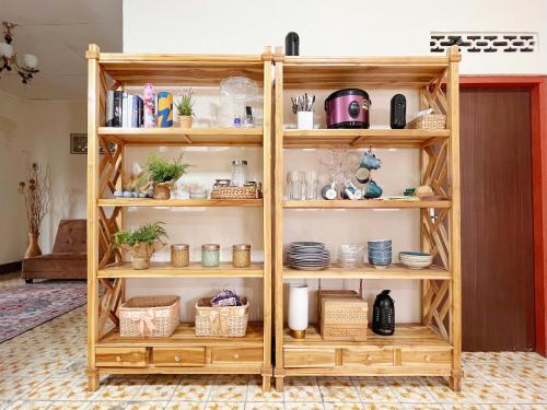 a wooden book shelf filled with lots of items at Bohaus in Alastuwo