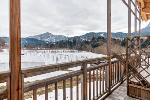 a view from the balcony of a cabin with snow on the ground at Agritur Maso Flonkeri in Bosentino