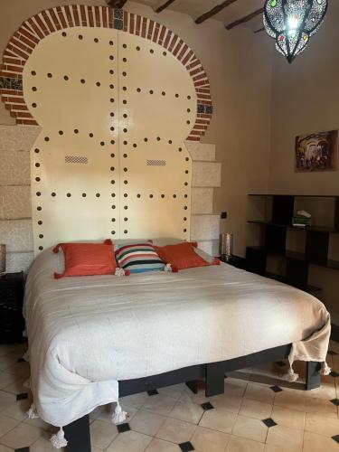 a bedroom with a large bed in a room at Riad Beldi by MaHa in Oulad Teima