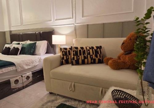 a living room with a couch and a teddy bear at SridaHouse#Near Central Festival Hat Yai in Sathani Khlong Rian