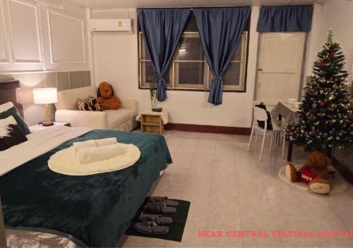 a living room with a christmas tree and a bed at SridaHouse#Near Central Festival Hat Yai in Sathani Khlong Rian