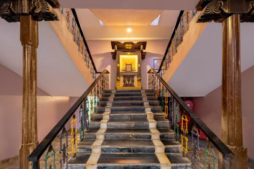 a staircase leading up to a yellow door at Sterling Palavelli Godavari in Rāzole