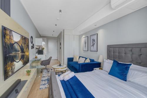 a bedroom with a blue bed and a blue couch at Bhonsane Executive Suite, Ellipse, Midrand in Midrand