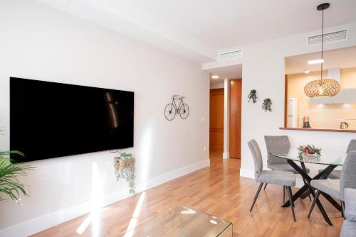 a living room with a flat screen tv on a wall at EnjoyGranada New Suite EMIR in Granada