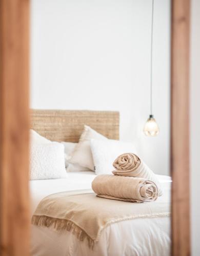 a bed with two towels sitting on top of it at EnjoyGranada New Suite EMIR in Granada