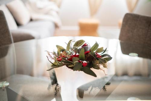 a flower arrangement on a glass table in a living room at EnjoyGranada New Suite EMIR in Granada