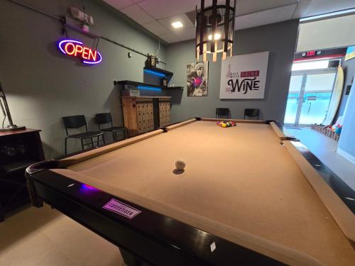 a large pool table in a room with a sign at BUNKER BEACH @ ISLA VERDE / Beach Front in San Juan