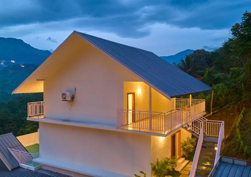 a house with a solarium on the roof at Ice Mist Pool Resort Munnar By VOYE HOMES in Munnar