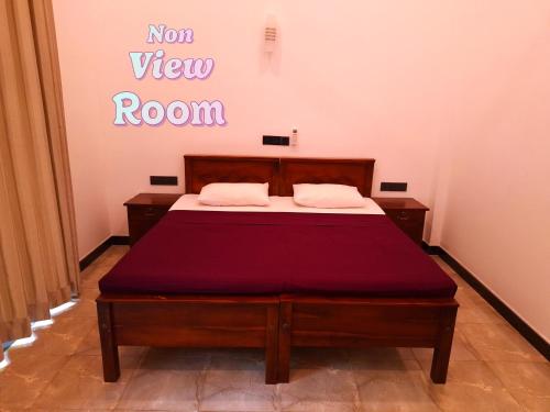 a bedroom with a bed with a not view room sign at Jaye's Homestay in Kandy