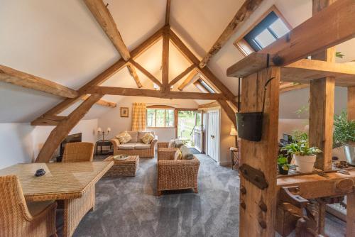 an open living room with wooden ceilings and beams at Hop Cottage Coddington Vineyard in Ledbury
