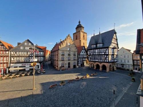a group of buildings in a town with a clock tower at Marktplatz Ferienwohnung in Alsfeld
