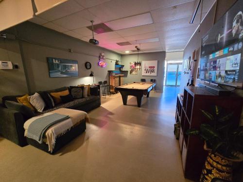 a living room with a couch and a pool table at BUNKER BEACH @ ISLA VERDE / Beach Front in San Juan