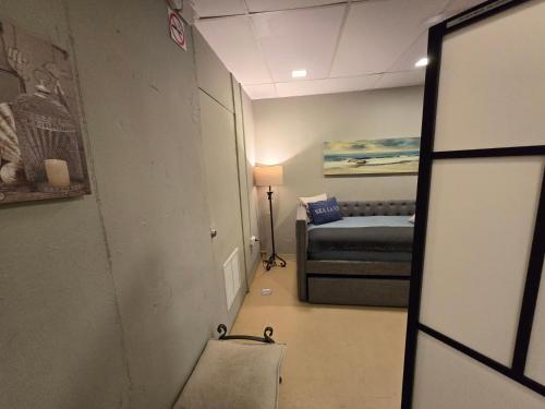 a small room with a bed and a mirror at BUNKER BEACH @ ISLA VERDE / Beach Front in San Juan