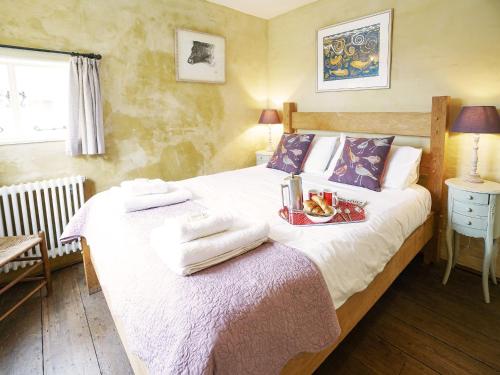 a bedroom with a bed with towels on it at Hidden Cottage by The Suffolk Cottage Collection in Aldeburgh