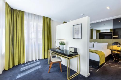 a hotel room with a bed and a desk at Altis Avenida Hotel in Lisbon