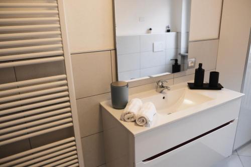 a bathroom with a sink and a mirror at Residenza famiglia Moser - Chalet Olimpico 2026 in Pergine Valsugana