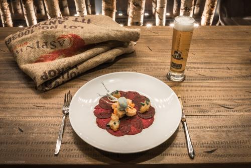 a plate of food on a table with a drink at Arkadenhaus - Hotel Freiherr von Schwarzenberg in Papenburg