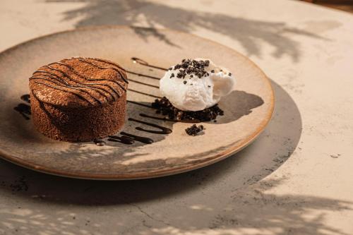 a plate with a piece of cake on a table at Leonardo Laura Beach & Splash Resort in Paphos City