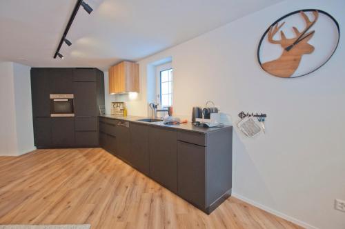 a kitchen with a sink and a counter top at Chalet Aeschhorn in Zermatt