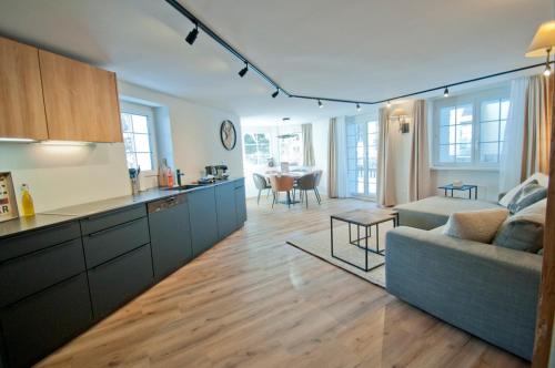 a kitchen and living room with a couch and a table at Chalet Aeschhorn in Zermatt